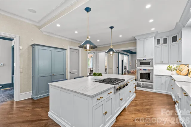 a kitchen with stainless steel appliances granite countertop a stove a sink and a refrigerator