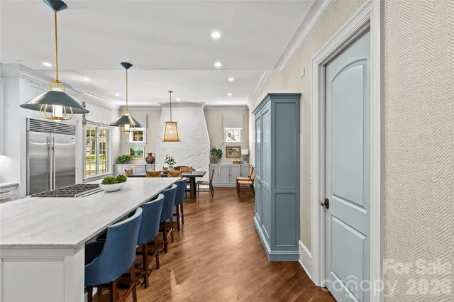 a kitchen with counter top space and wooden floor