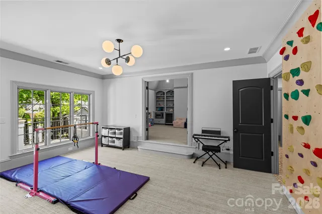 a bedroom with furniture and a baby crib