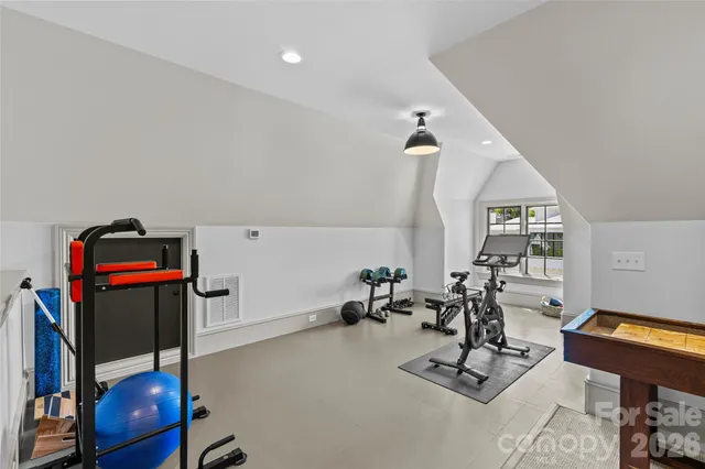 a living room with furniture and large windows