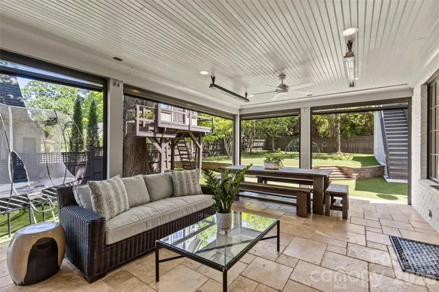 a backyard of a house with table and chairs