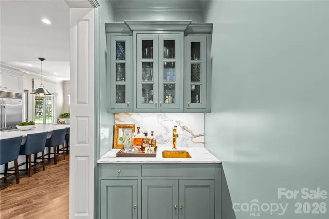 a hallway with a sink and cabinets
