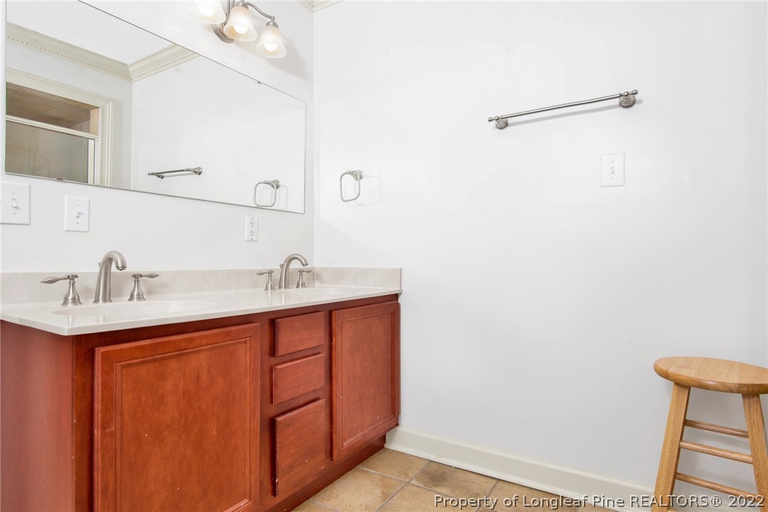 1813 Ashton Road Fayetteville, NC 28304 - Photo 11 of 25 a bathroom with a sink and a mirror