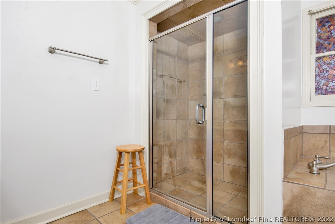 1813 Ashton Road Fayetteville, NC 28304 - Photo 13 of 25 a bathroom with a glass shower door