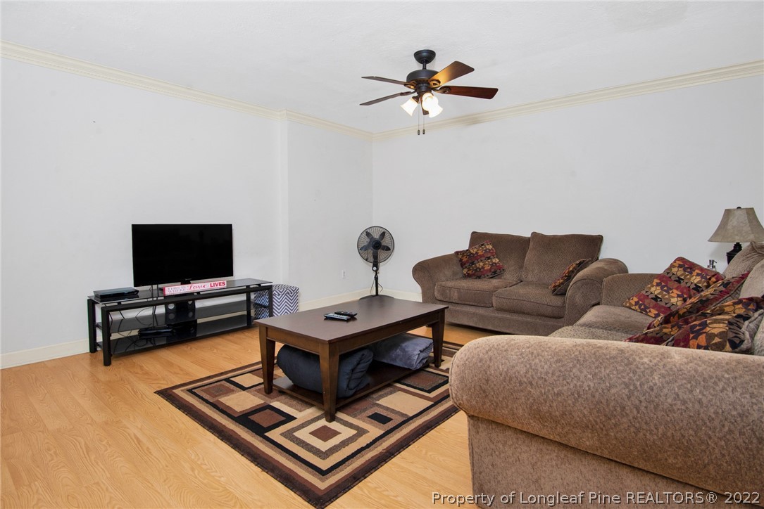 1813 Ashton Road Fayetteville, NC 28304 - Photo 4 of 25 a living room with furniture and a flat screen tv