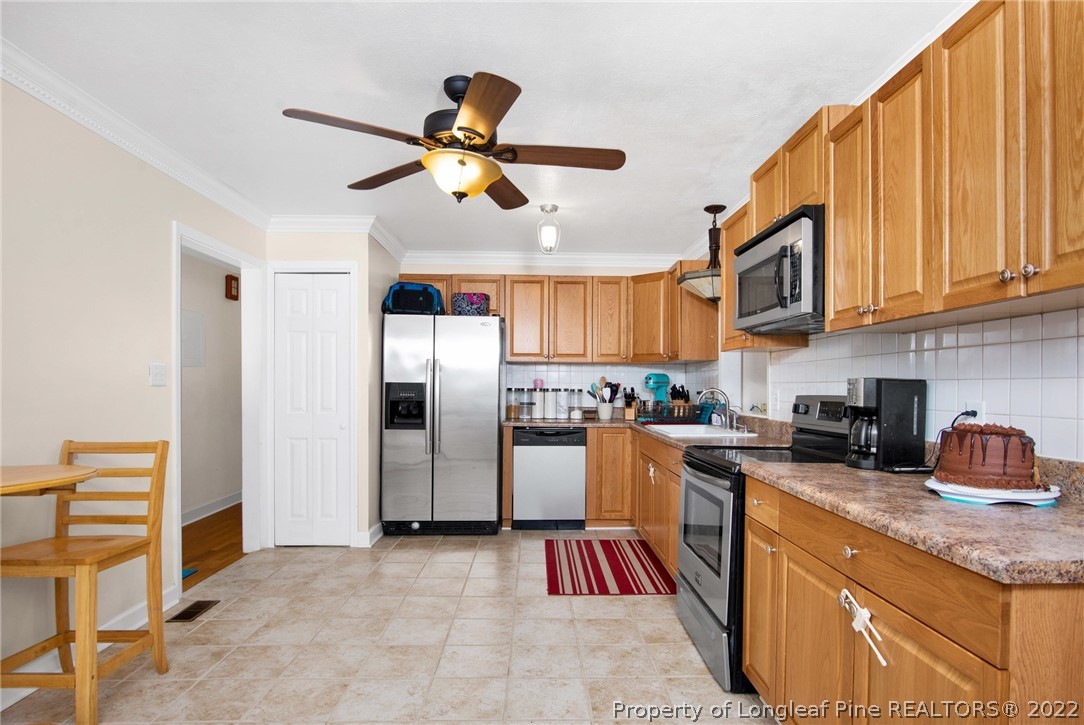 1813 Ashton Road Fayetteville, NC 28304 - Photo 6 of 25 a kitchen with stainless steel appliances granite countertop a refrigerator and a sink