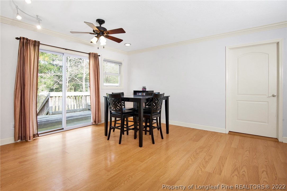 1813 Ashton Road Fayetteville, NC 28304 - Photo 8 of 25 a view of a livingroom with furniture wooden floor and a ceiling fan