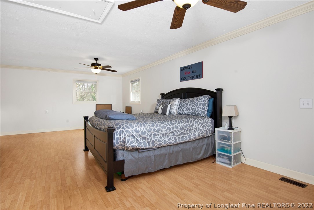 1813 Ashton Road Fayetteville, NC 28304 - Photo 9 of 25 a bedroom with a bed and ceiling fan