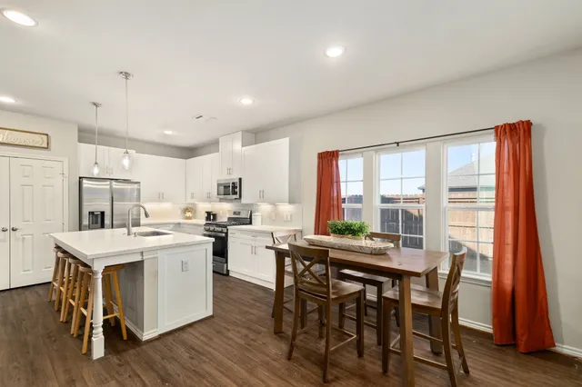 a kitchen with a table and chairs in it