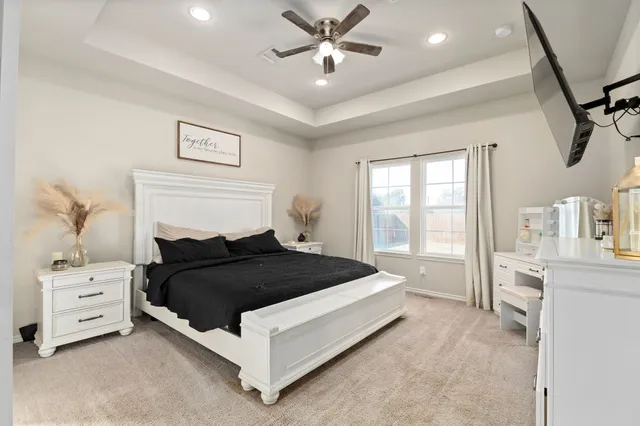 a bedroom with a bed and a chandelier