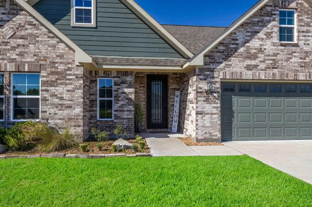 a view of a chair and table in backyard of the house