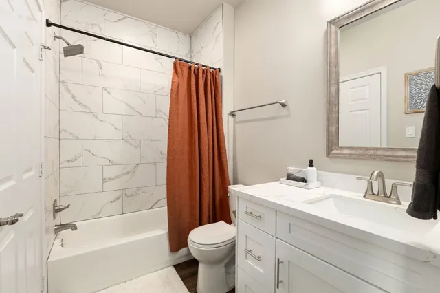 a bathroom with a sink toilet and shower