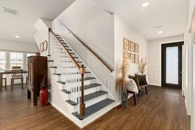 a view of entryway with wooden floor and stairs