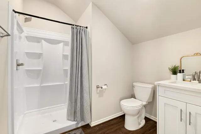 a white toilet sitting next to a bathroom sink