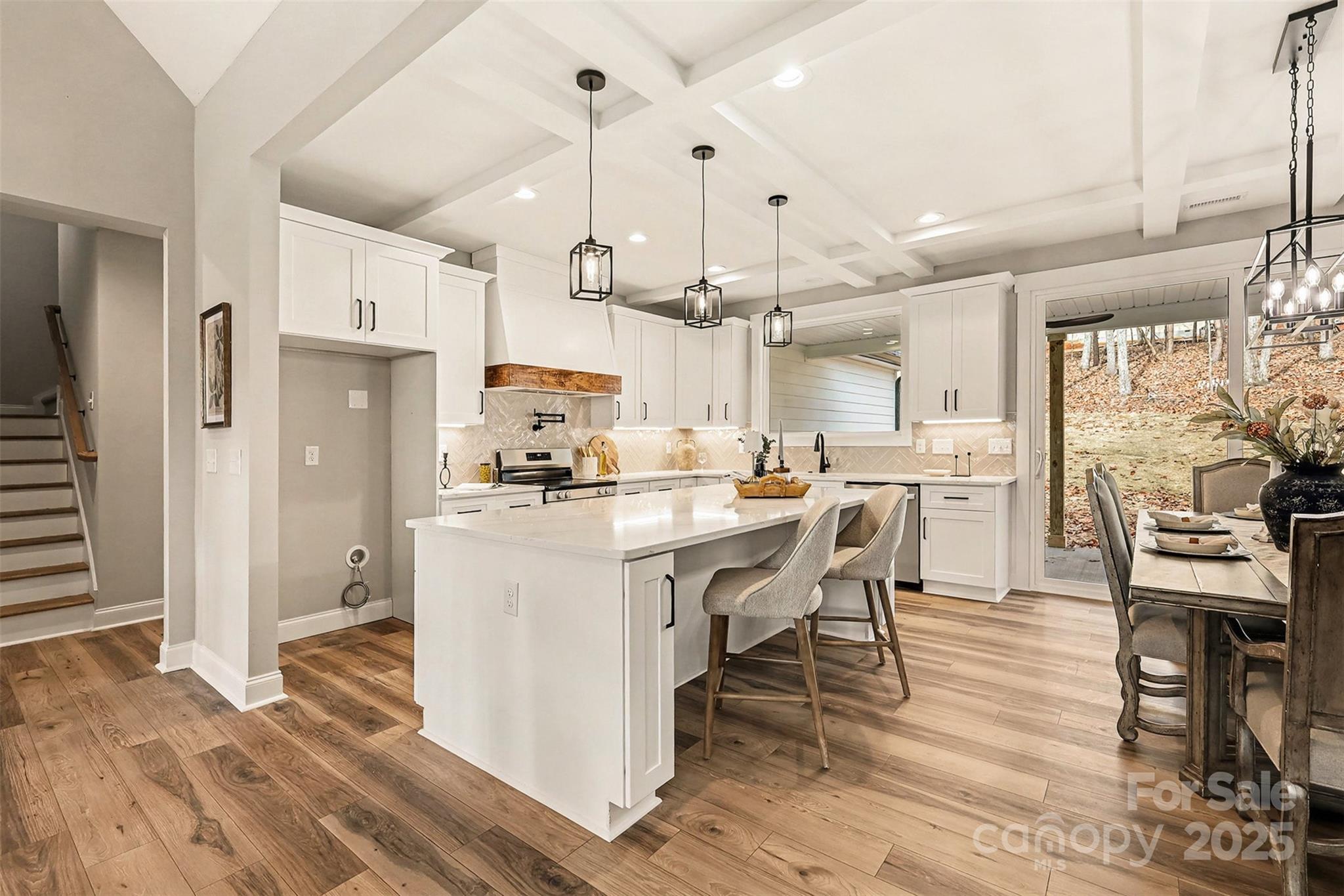 5304 West Liberty Hill Road York, SC 29745 - Photo 13 of 41 a kitchen with stainless steel appliances kitchen island granite countertop a refrigerator a stove and white cabinets with wooden floor