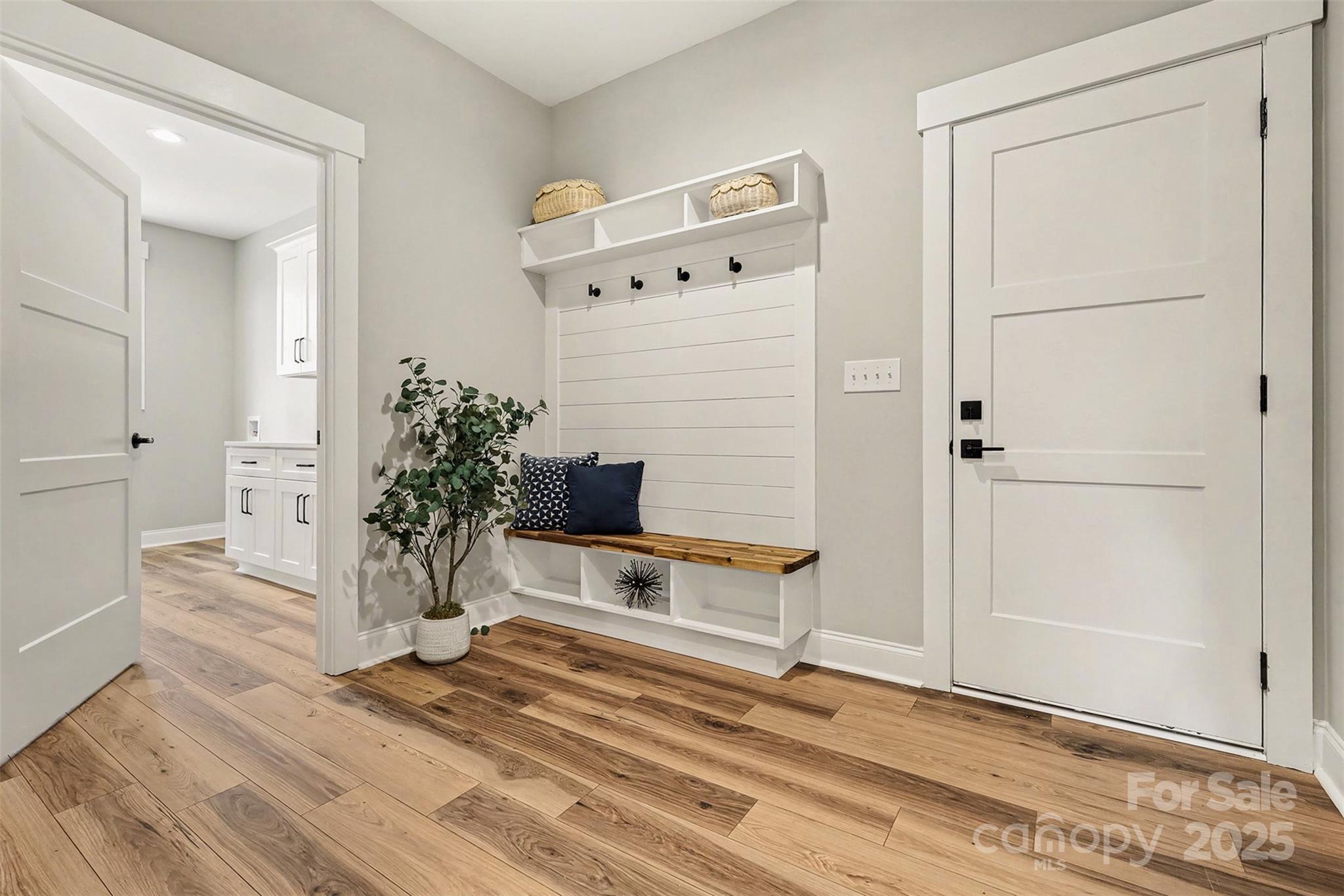 5304 West Liberty Hill Road York, SC 29745 - Photo 23 of 41 a view of a hallway with wooden floor and a potted plant