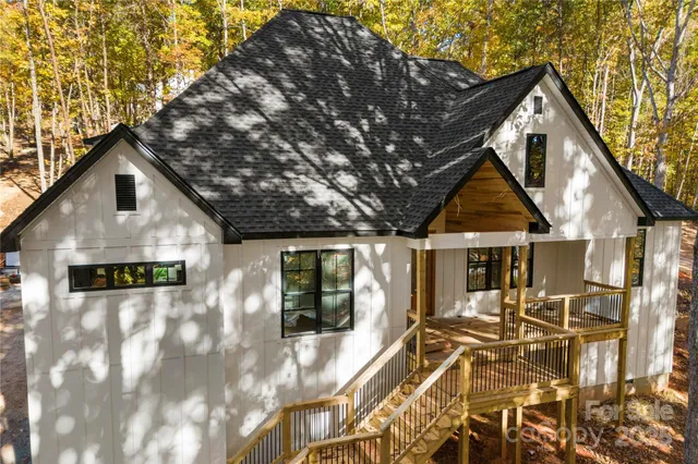 a view of a house with a yard covered in snow
