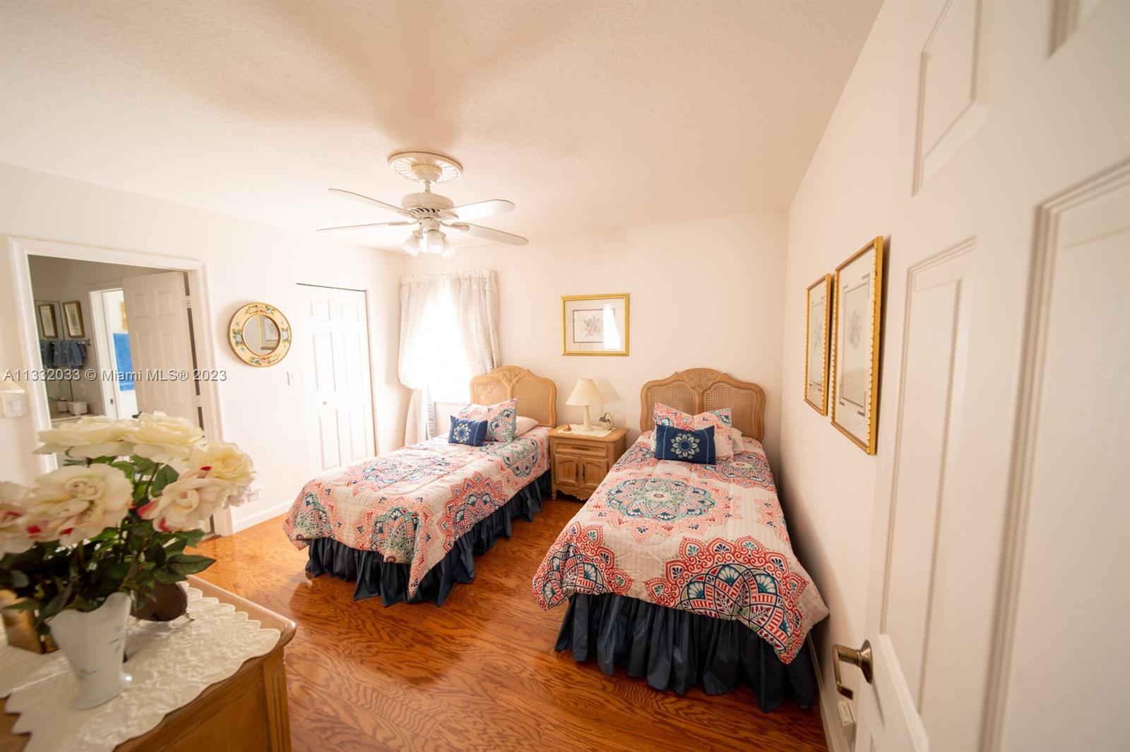 3961 Nighthawk Drive Weston, FL 33331 - Photo 17 of 35 a bedroom with two beds and a chandelier