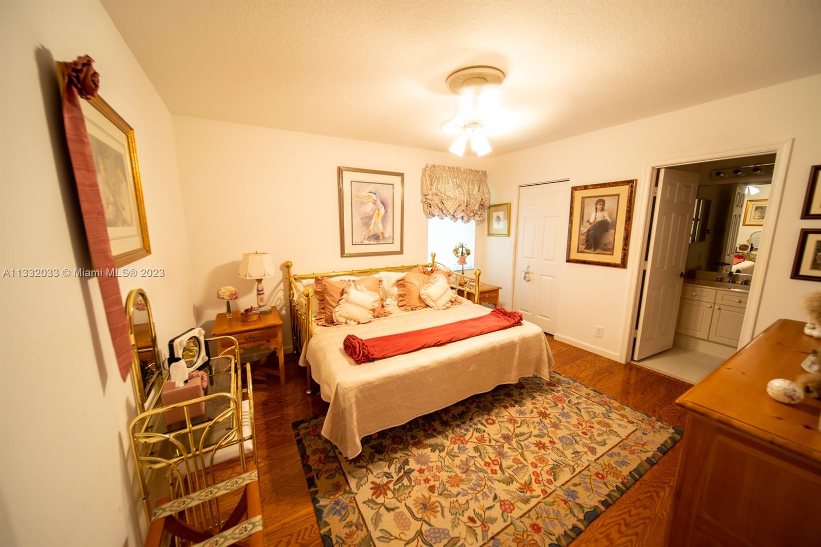 3961 Nighthawk Drive Weston, FL 33331 - Photo 20 of 35 a bedroom with a bed and wooden floor