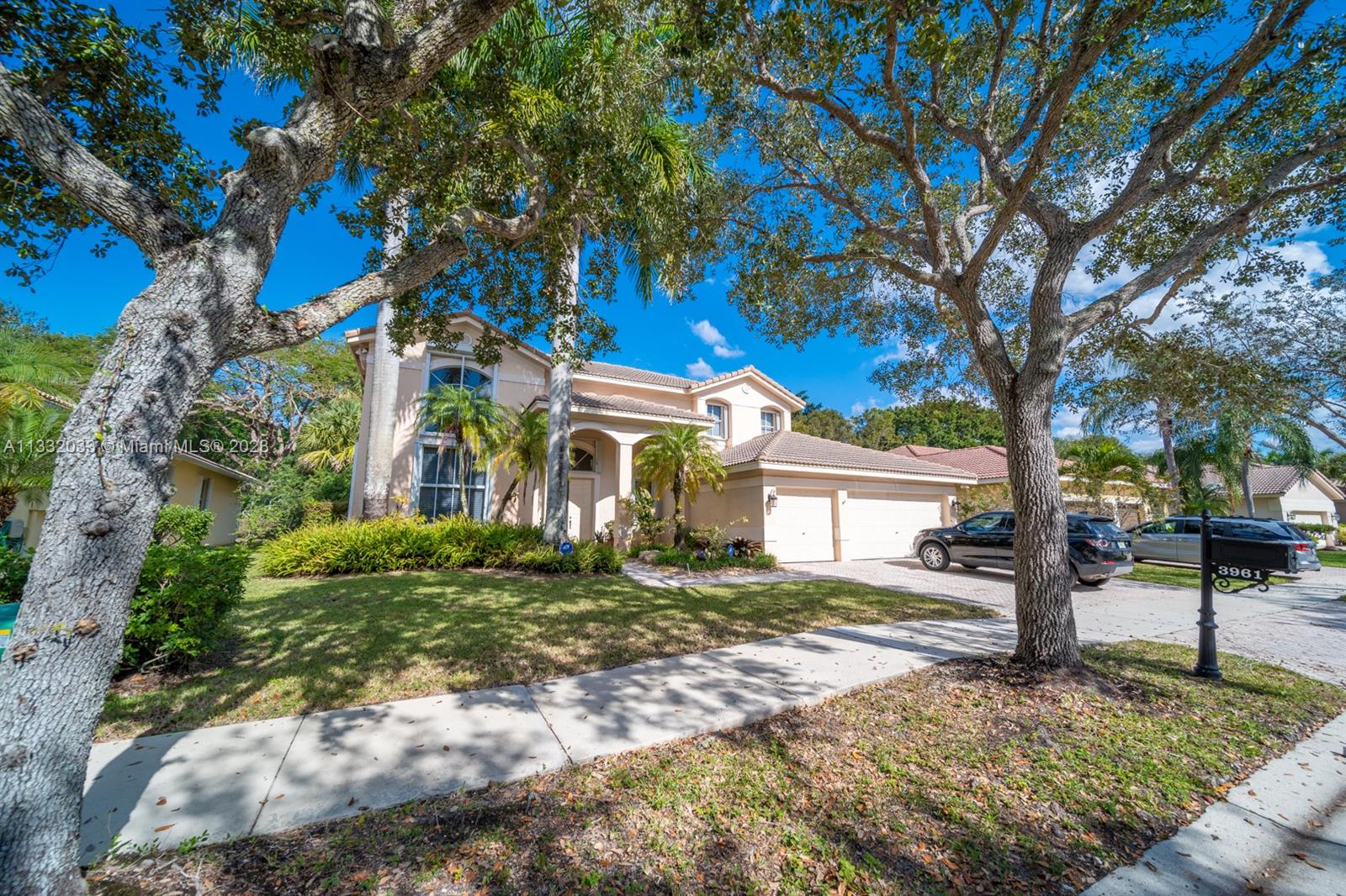 3961 Nighthawk Drive Weston, FL 33331 - Photo 3 of 35 a view of a house with a tree in front of it