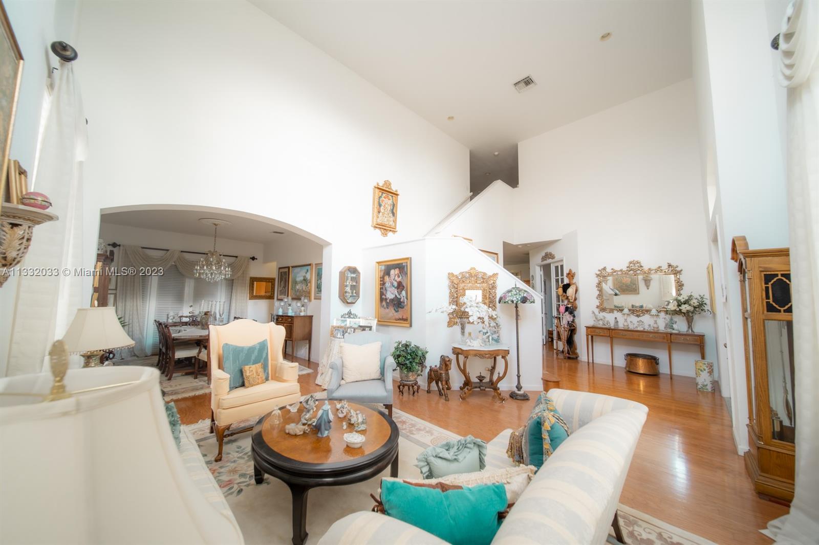 3961 Nighthawk Drive Weston, FL 33331 - Photo 5 of 35 a living room with furniture a rug and a chandelier