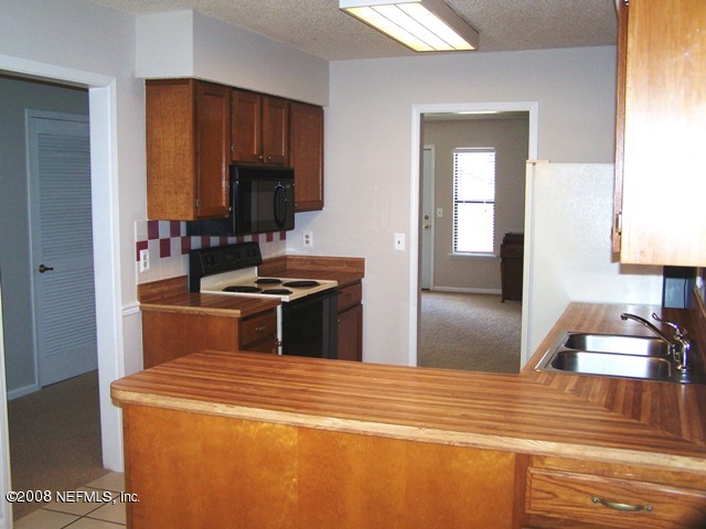 11036 Reading Road Jacksonville, FL 32257 - Photo 11 of 22 a kitchen with a stove and a sink