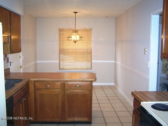 11036 Reading Road Jacksonville, FL 32257 - Photo 12 of 22 a kitchen with a sink a stove cabinets and a window