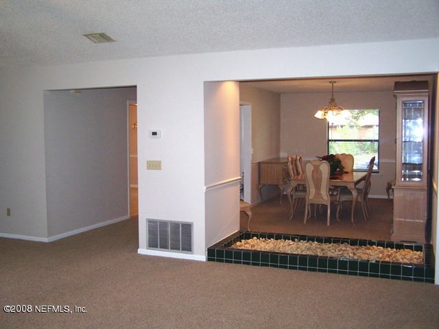 11036 Reading Road Jacksonville, FL 32257 - Photo 14 of 22 a living room with furniture a large window and dining table