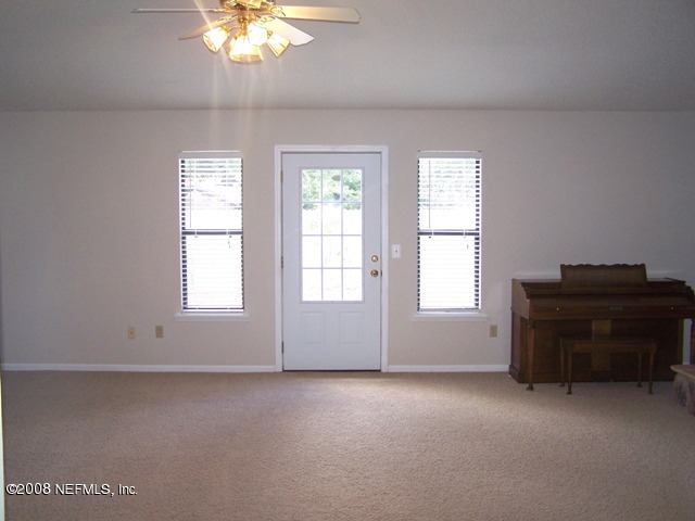 11036 Reading Road Jacksonville, FL 32257 - Photo 17 of 22 an empty room with a window and a ceiling fan