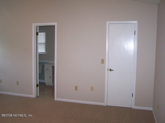 11036 Reading Road Jacksonville, FL 32257 - Photo 18 of 22 a view of an empty room with closet and mirror