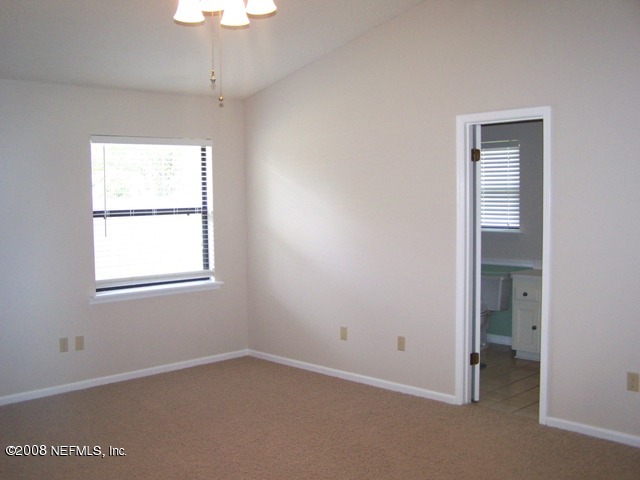 11036 Reading Road Jacksonville, FL 32257 - Photo 19 of 22 an empty room with a window and a chandelier fan