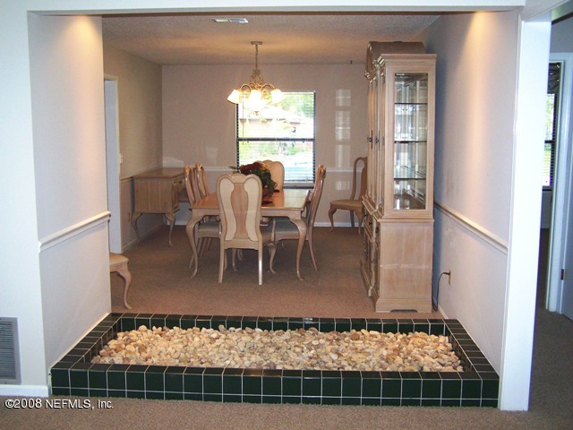 11036 Reading Road Jacksonville, FL 32257 - Photo 2 of 22 a view of a dining room with furniture window and wooden floor
