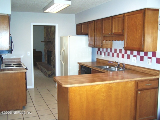 11036 Reading Road Jacksonville, FL 32257 - Photo 3 of 22 a kitchen with stainless steel appliances a refrigerator and a stove