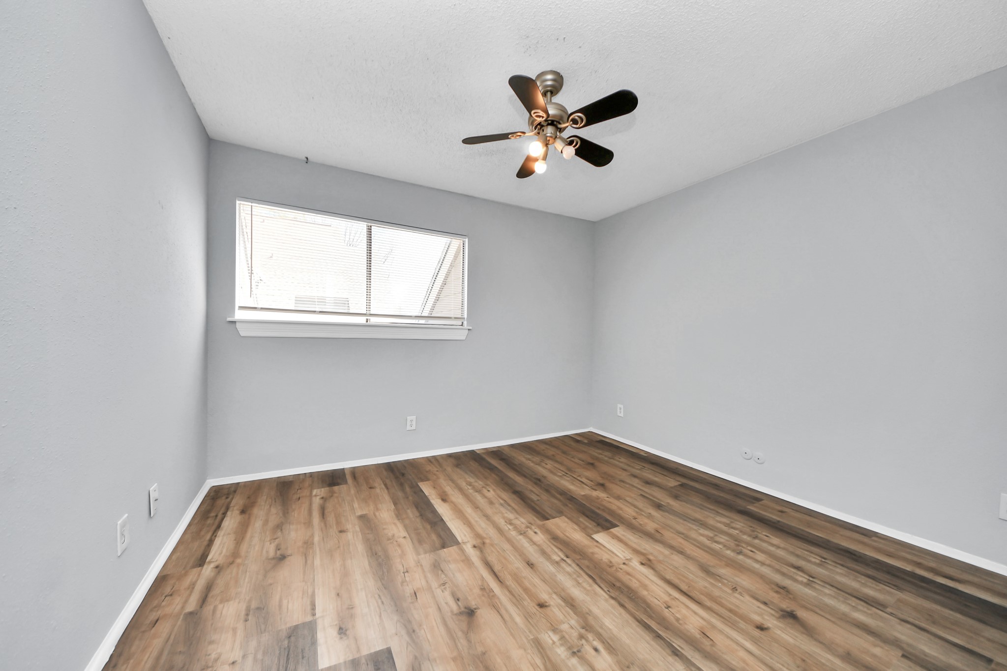 6601 Sands Point Drive, Unit 30 Houston, TX 77074 - Photo 11 of 29 wooden floor in an empty room with a window