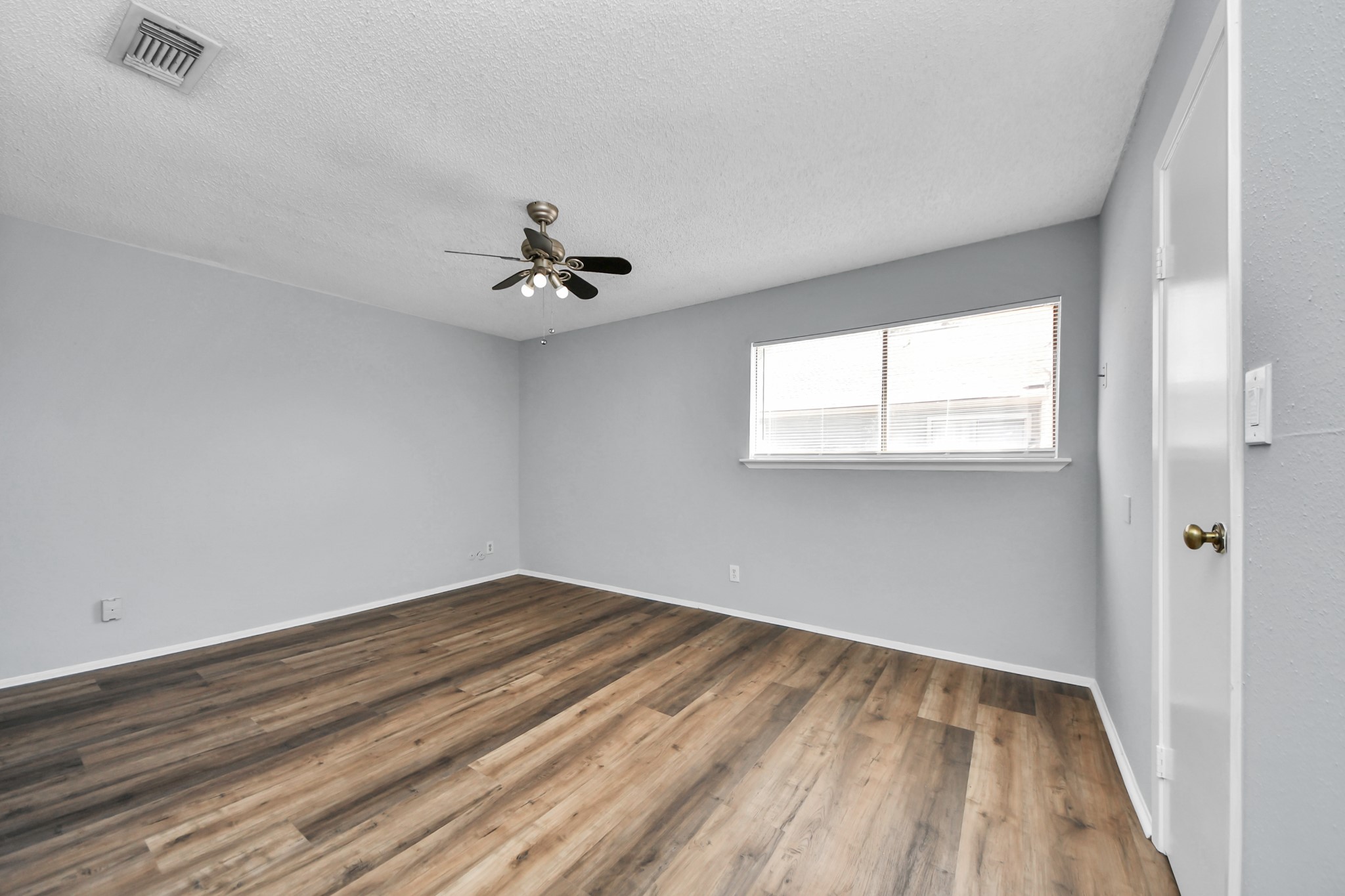 6601 Sands Point Drive, Unit 30 Houston, TX 77074 - Photo 16 of 29 wooden floor in an empty room with a window