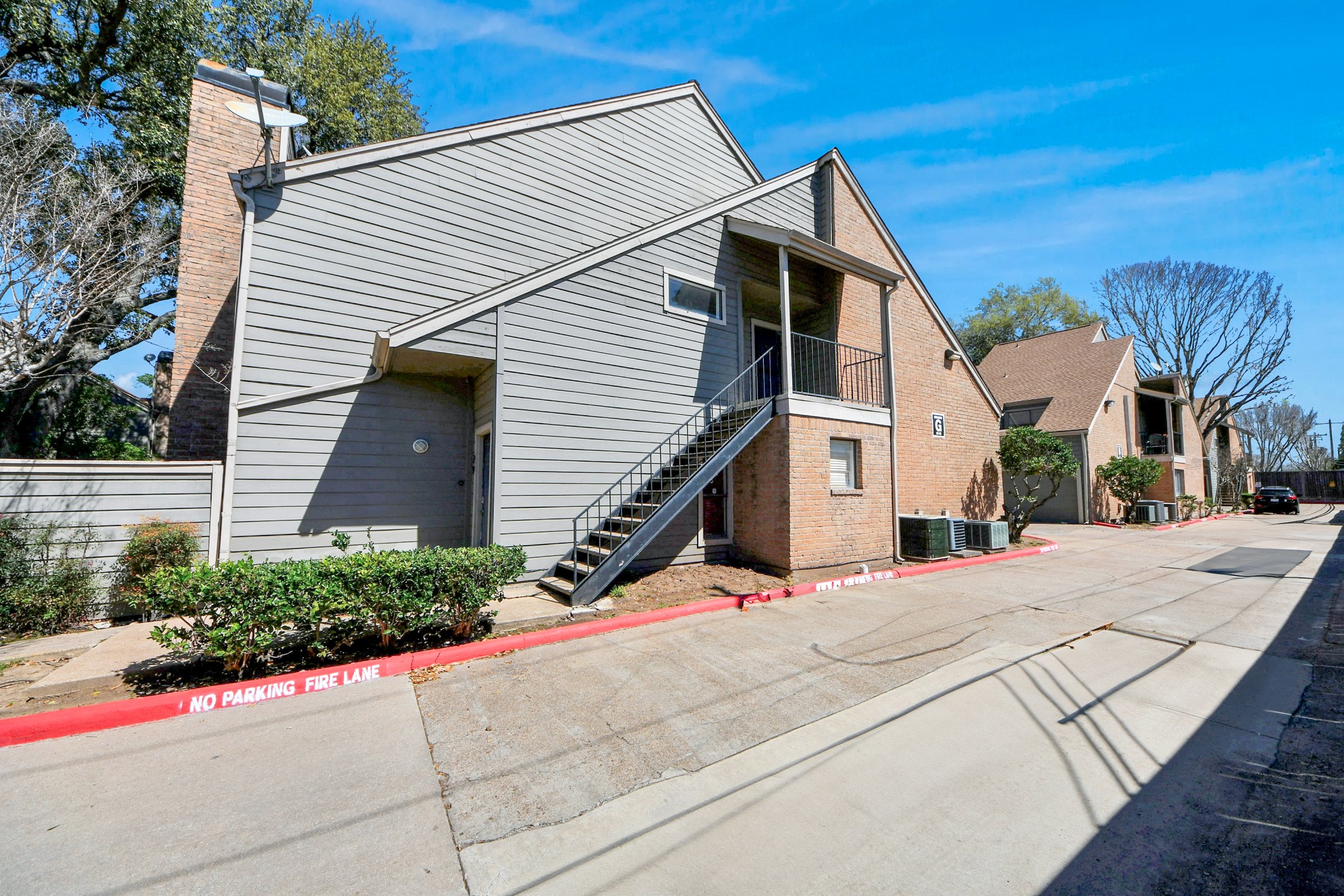 6601 Sands Point Drive, Unit 30 Houston, TX 77074 - Photo 24 of 29 a view of a white house with a yard and potted plants