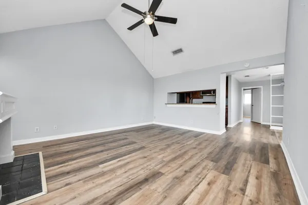 wooden floor in an empty room with a window