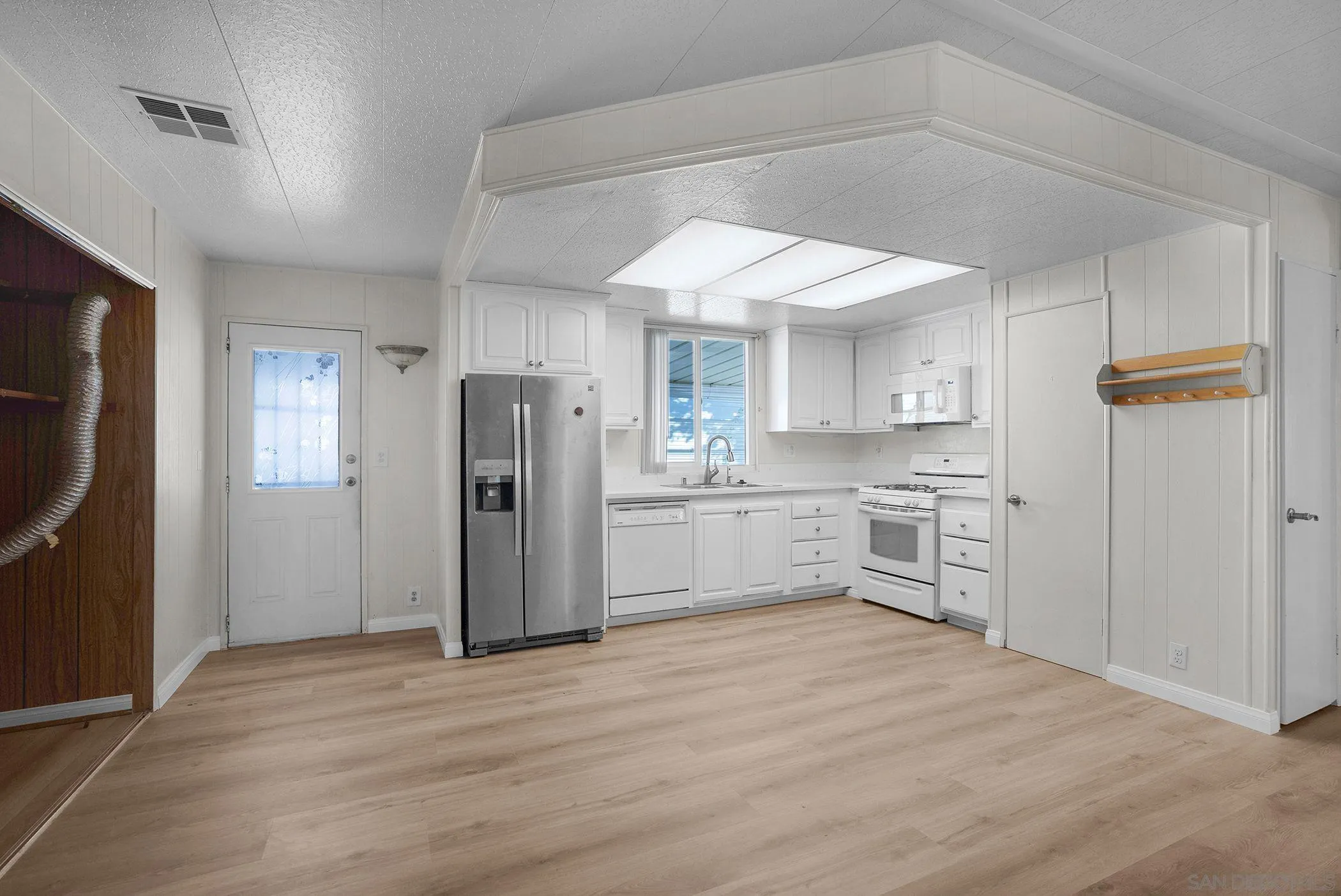 1925 Otay Lakes Road, Unit 167 Chula Vista, CA 91913 - Photo 3 of 11 a kitchen with stainless steel appliances granite countertop a refrigerator and a sink