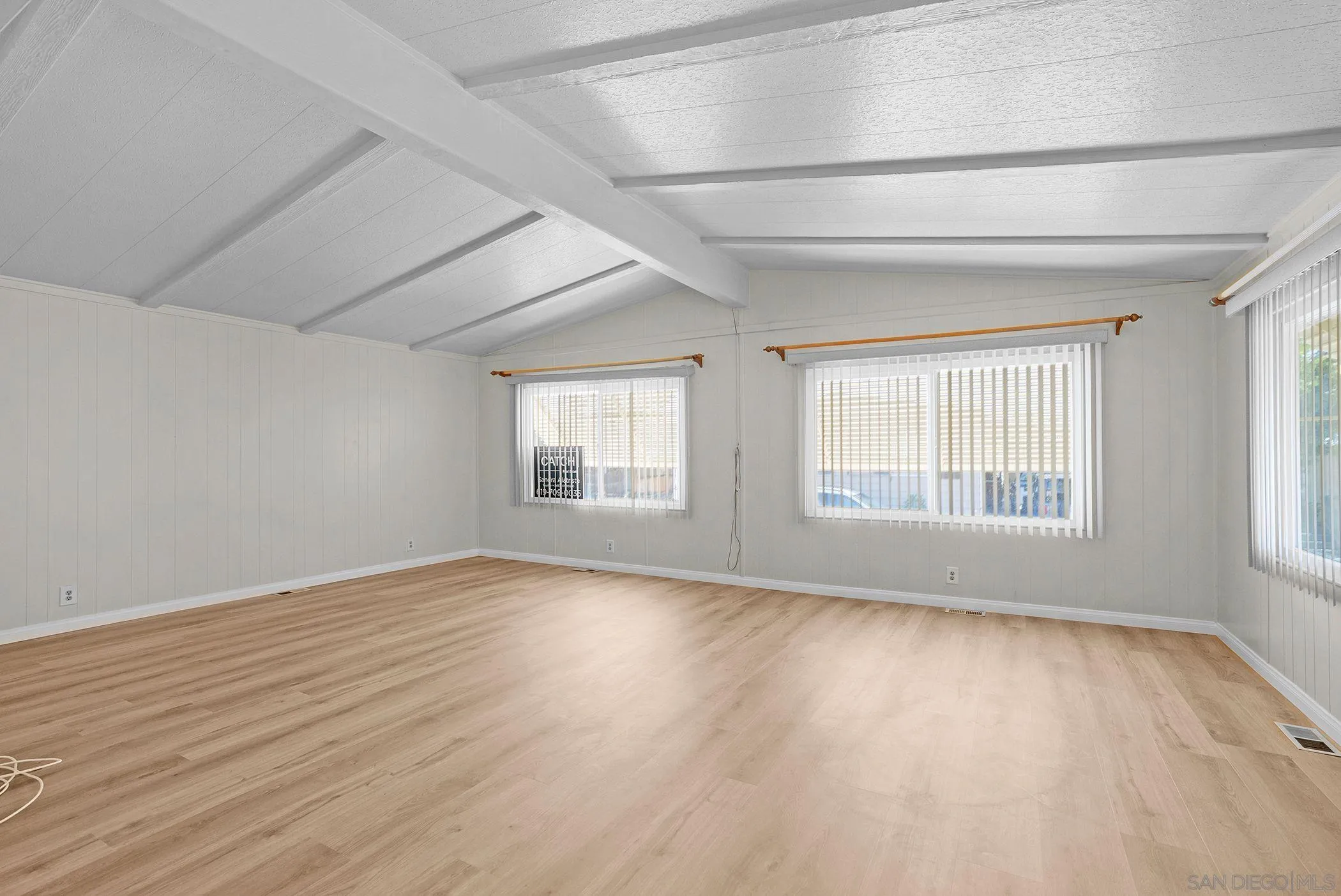 1925 Otay Lakes Road, Unit 167 Chula Vista, CA 91913 - Photo 8 of 11 an empty room with wooden floor and windows