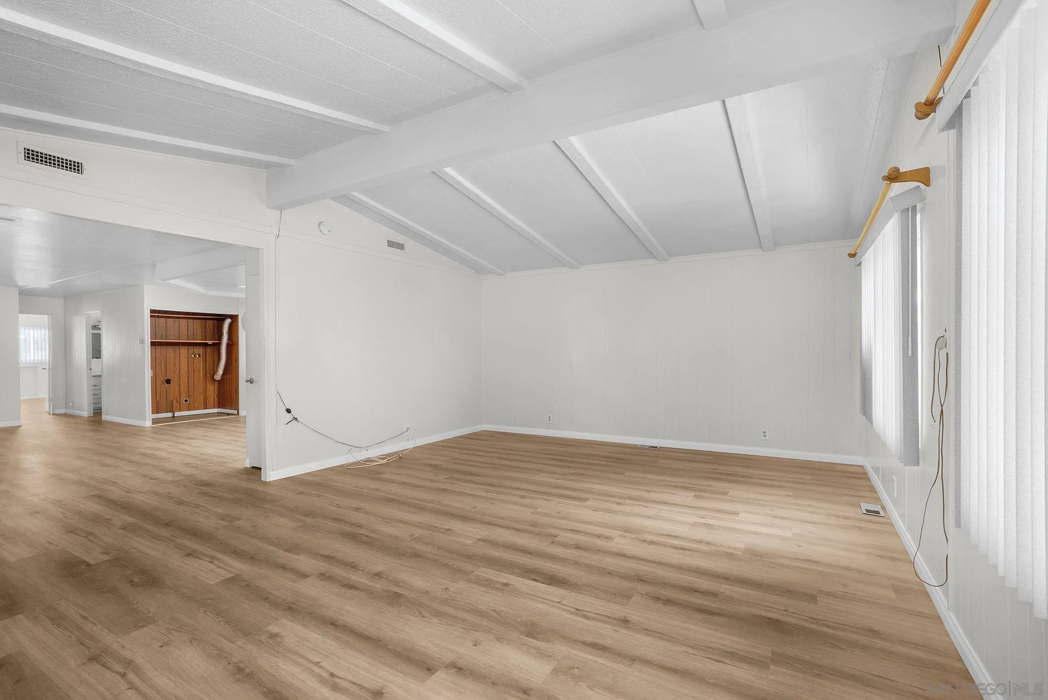 1925 Otay Lakes Road, Unit 167 Chula Vista, CA 91913 - Photo 9 of 11 wooden floor in an empty room with a window