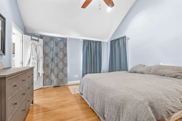 a spacious bedroom with a bed and a dresser