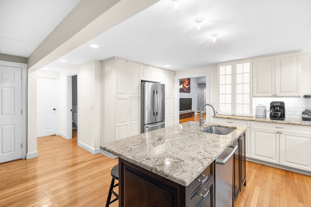 486 Washington Street Walpole, MA 02032 - Photo 6 of 17 a kitchen with granite countertop kitchen island a table and chairs in it