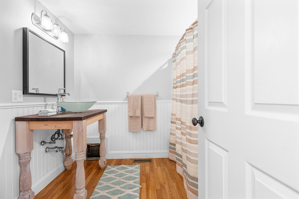 486 Washington Street Walpole, MA 02032 - Photo 10 of 17 a bathroom with a sink and a mirror