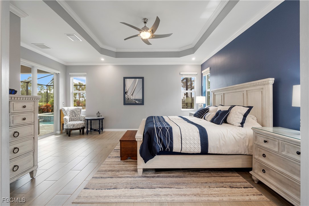 43276 Boardwalk Loop Punta Gorda, FL 33982 - Photo 18 of 50 a spacious bedroom with a bed a couch and a bookshelf