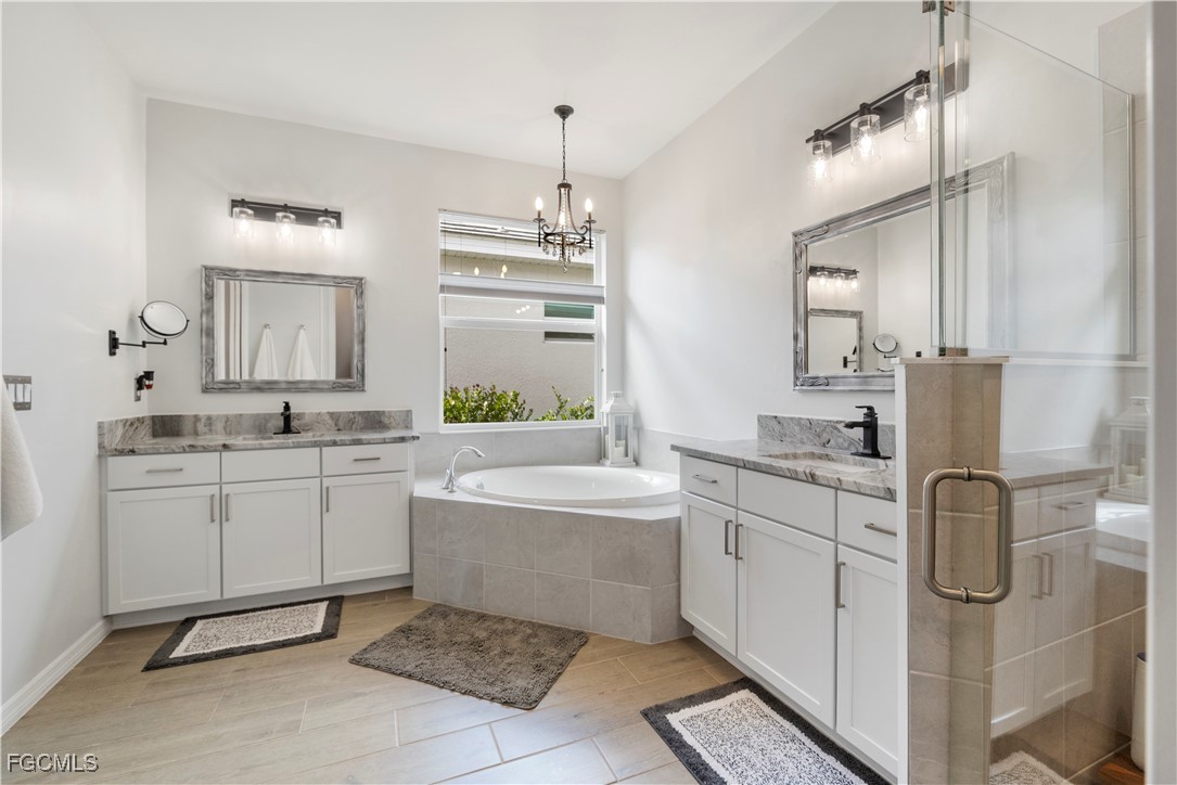 43276 Boardwalk Loop Punta Gorda, FL 33982 - Photo 22 of 50 a bathroom with a granite countertop sink a toilet a mirror and shower