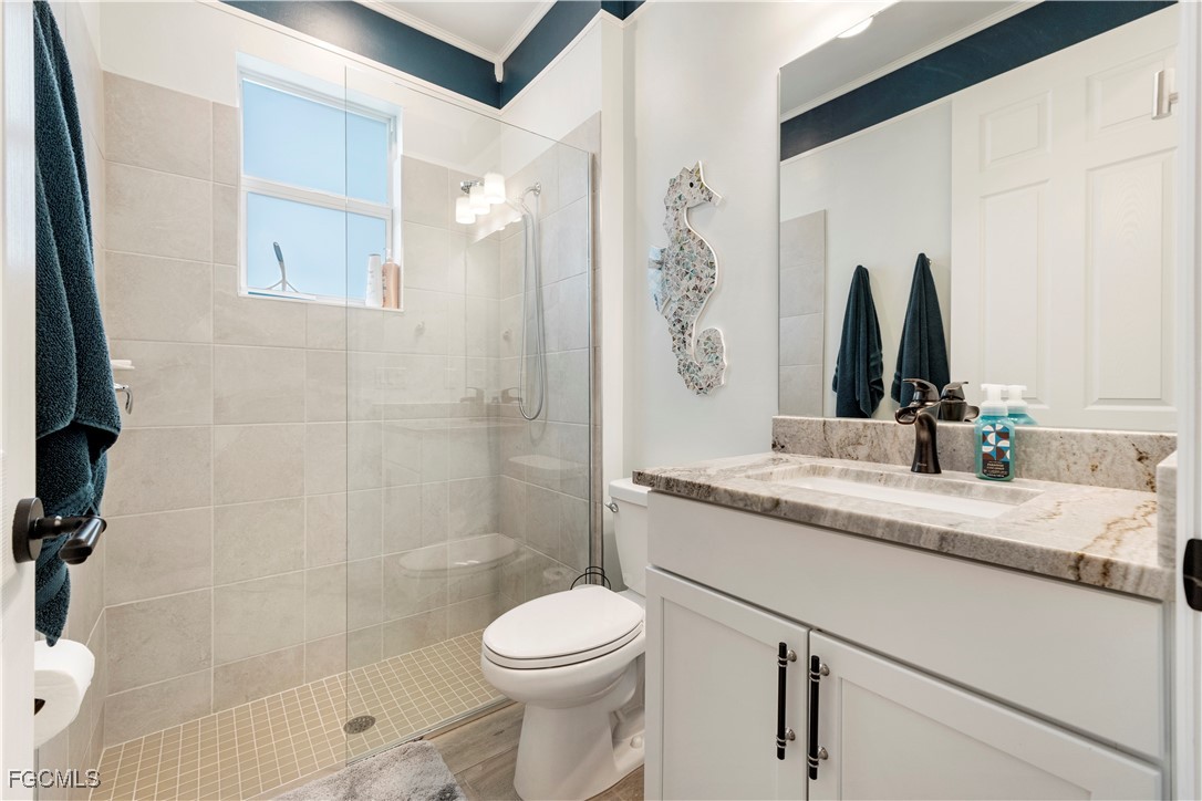 43276 Boardwalk Loop Punta Gorda, FL 33982 - Photo 26 of 50 a bathroom with a granite countertop sink a toilet and shower