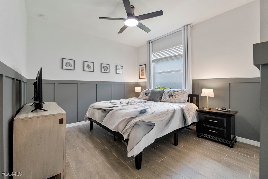 43276 Boardwalk Loop Punta Gorda, FL 33982 - Photo 27 of 50 a bedroom with a bed and a chandelier