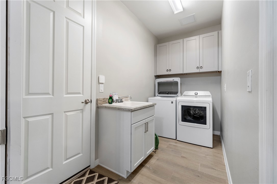 43276 Boardwalk Loop Punta Gorda, FL 33982 - Photo 28 of 50 a kitchen with white cabinets and white appliances