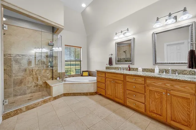 a large bathroom with a large tub sink shower and mirror