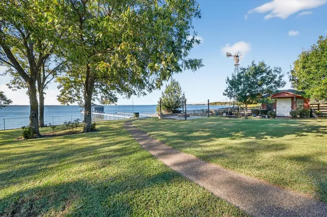 a yard with lots of green space and trees